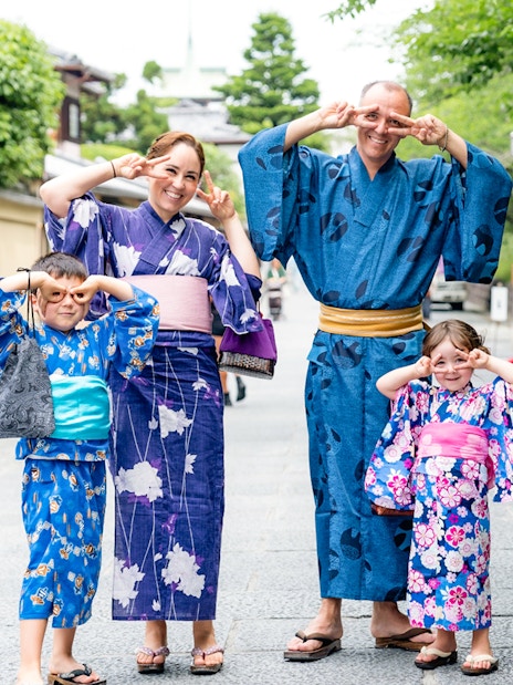 Guests in kimonos posing at Kyoto Kimono Rental, Japan.