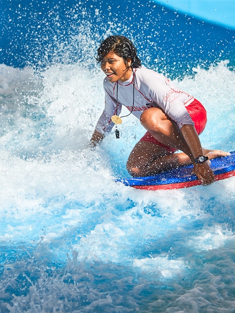 Person surfing at Wild Wadi Waterpark, Dubai.