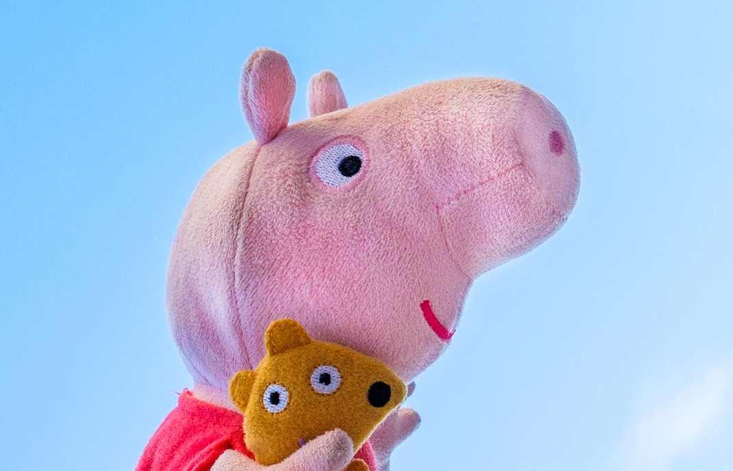 Peppa Pig plush toy holding a smaller toy at Peppa Pig World.