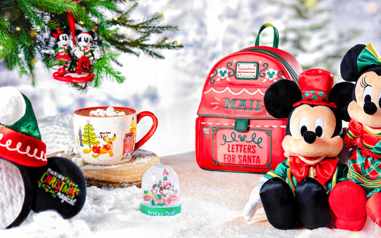 Disneyland Christmas 2025 decorations with Mickey Mouse plush, festive mug, and Santa mail bag.
