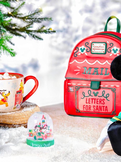 Disneyland Christmas 2025 decorations with Mickey Mouse plush, festive mug, and Santa mail bag.