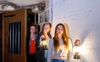 Visitors holding lanterns during Port Arthur Historic Site Ghost Tour.