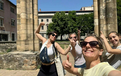 Group enjoying Lyon Murder Mystery game near ancient ruins in Lyon.