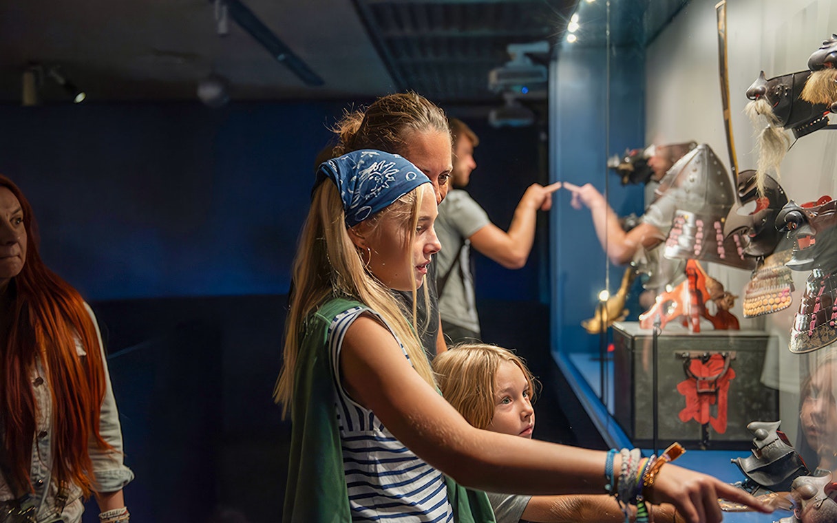 Visitors exploring samurai armor display at Berlin's Samurai Museum.