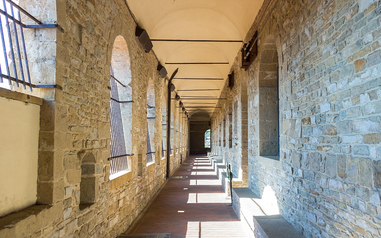 Palazzo Vecchio stone corridor with arched windows in Florence.