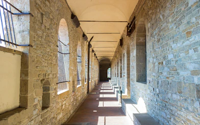 Palazzo Vecchio stone corridor with arched windows in Florence.
