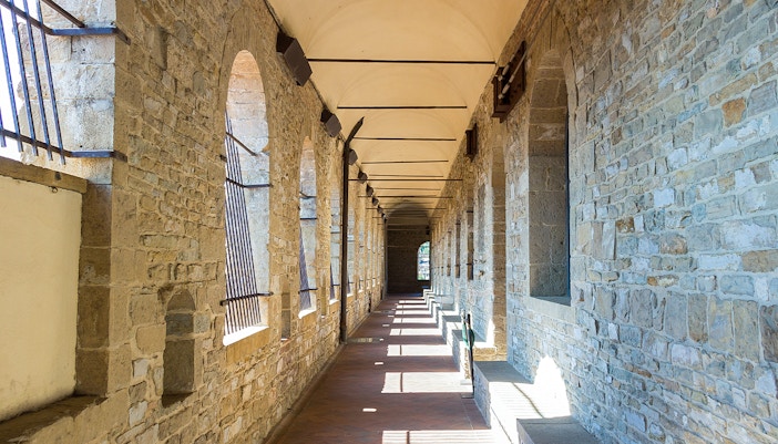 Palazzo Vecchio stone corridor with arched windows in Florence.