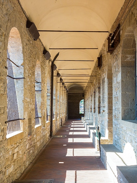 Palazzo Vecchio stone corridor with arched windows in Florence.