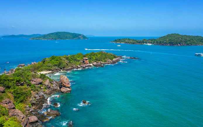Aerial view of Gam Ghi Phu Quoc island with boats and rocky coastline.