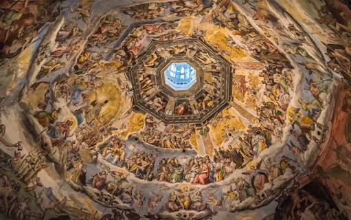 Fresco inside Florence's Duomo dome, depicting religious scenes, part of Accademia Gallery tour.
