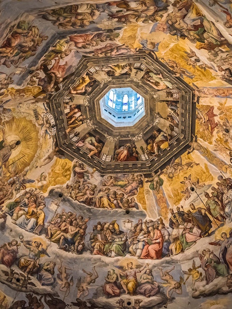 Fresco inside Florence's Duomo dome, depicting religious scenes, part of Accademia Gallery tour.