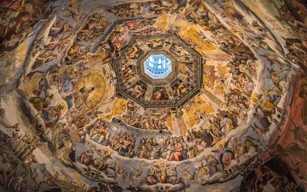 Fresco inside Florence's Duomo dome, depicting religious scenes, part of Accademia Gallery tour.