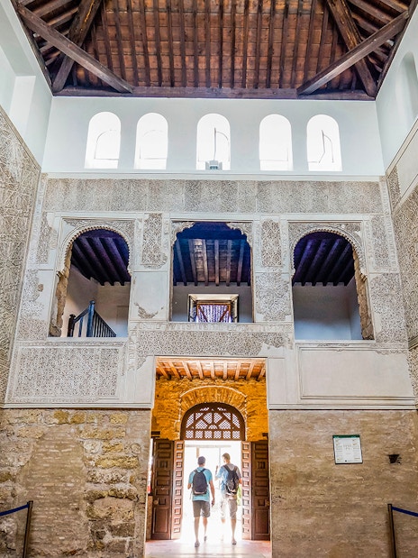 Interior of Cordoba Mosque-Cathedral with intricate arches and stone walls.