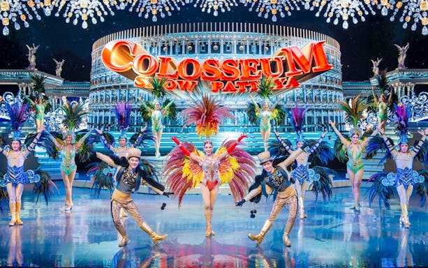 Performers in vibrant costumes on stage at Colosseum Cabaret Show Pattaya.
