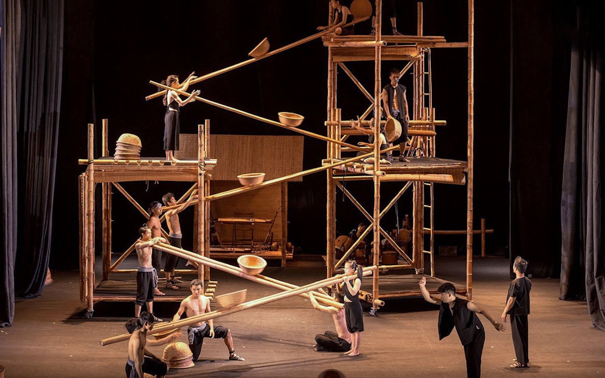 Performers balancing on bamboo scaffolding at A O Show circus in Vietnam.