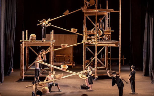 Performers balancing on bamboo scaffolding at A O Show circus in Vietnam.