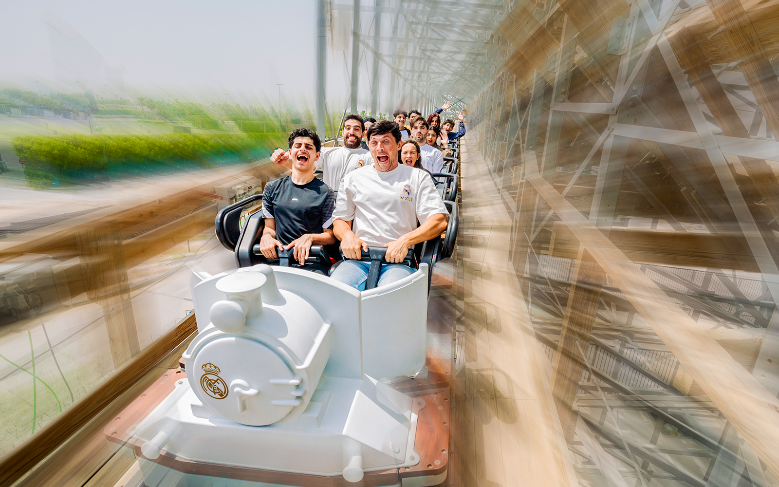 People enjoying the Hala Madrid coaster ride at Real World Madrid, Dubai.