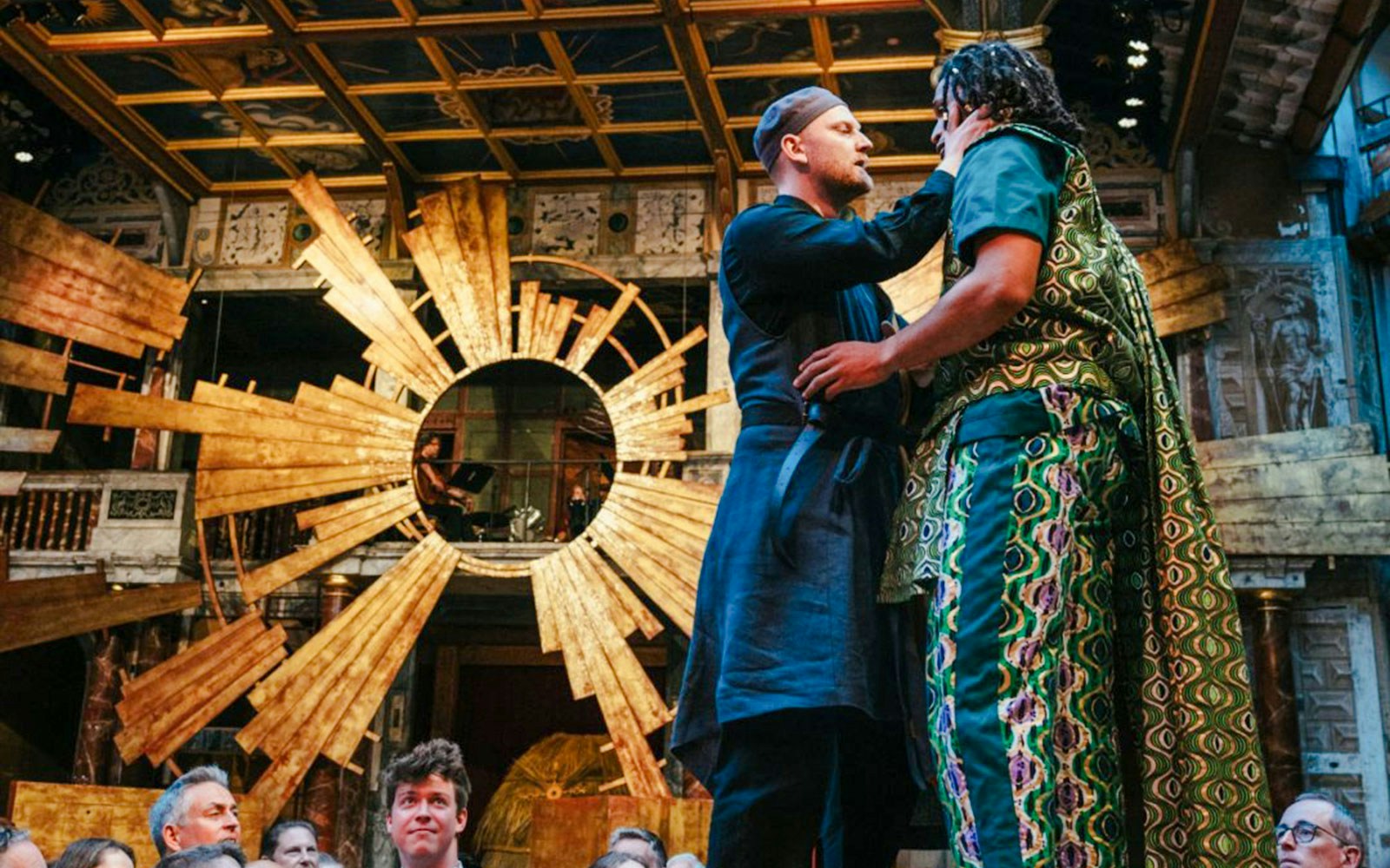 Actors performing Twelfth Night on stage with ornate backdrop.