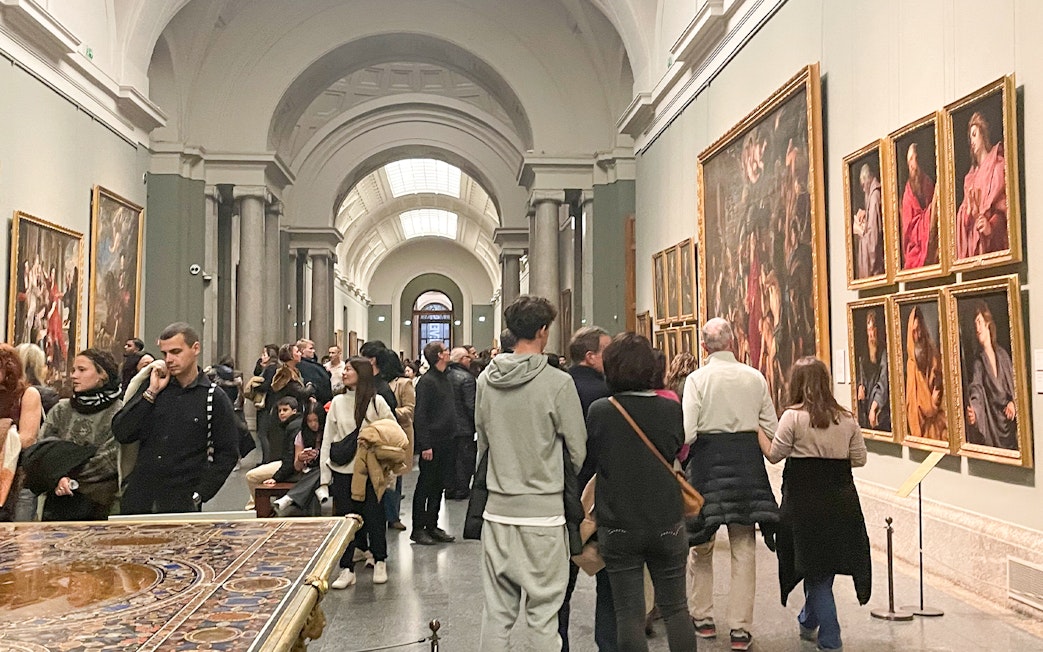 Group tour with guide at Prado Museum exhibition hall, Madrid.