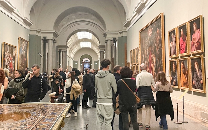 Group tour with guide at Prado Museum exhibition hall, Madrid.