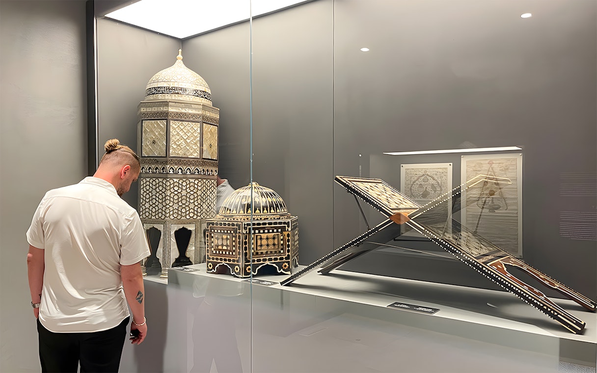 Visitor viewing intricate artifacts at Hagia Sophia Museum, Istanbul.