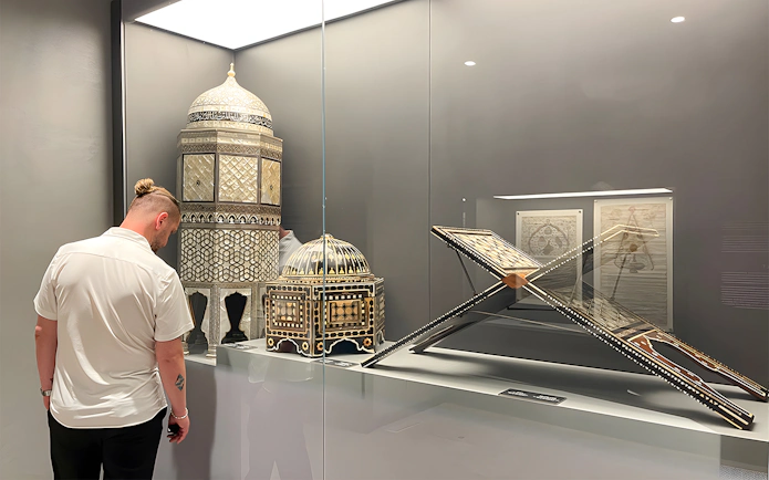 Visitor viewing intricate artifacts at Hagia Sophia Museum, Istanbul.
