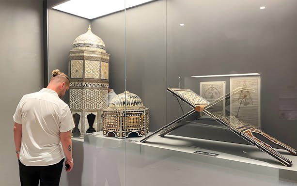 Visitor viewing intricate artifacts at Hagia Sophia Museum, Istanbul.