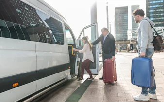 Travelers boarding a van for private airport transfer at Kota Kinabalu International Airport.