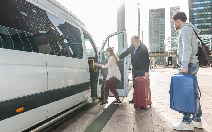 Travelers boarding a van for private airport transfer at Kota Kinabalu International Airport.