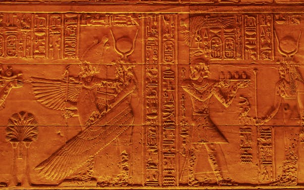 Carved hieroglyphs on the Temple of Isis walls, Philae Island, Egypt.