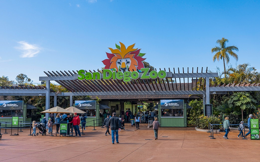 San Diego Zoo entrance with visitors and ticket booths.
