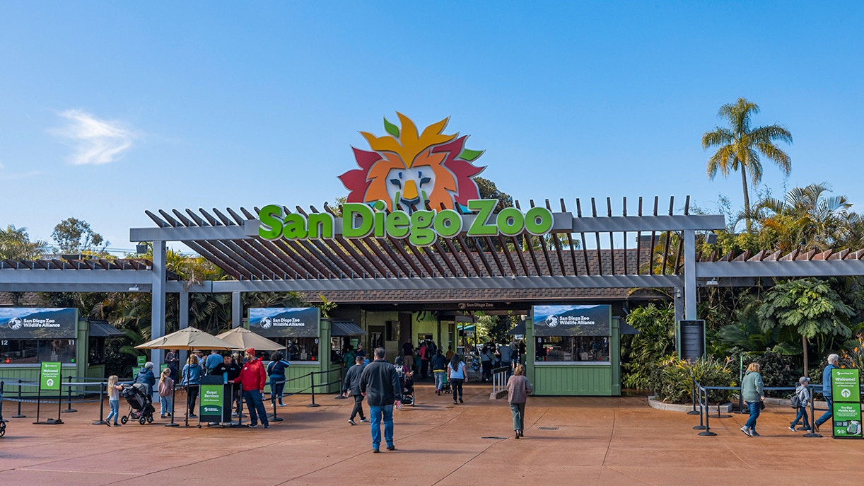 San Diego Zoo entrance with visitors and ticket booths.