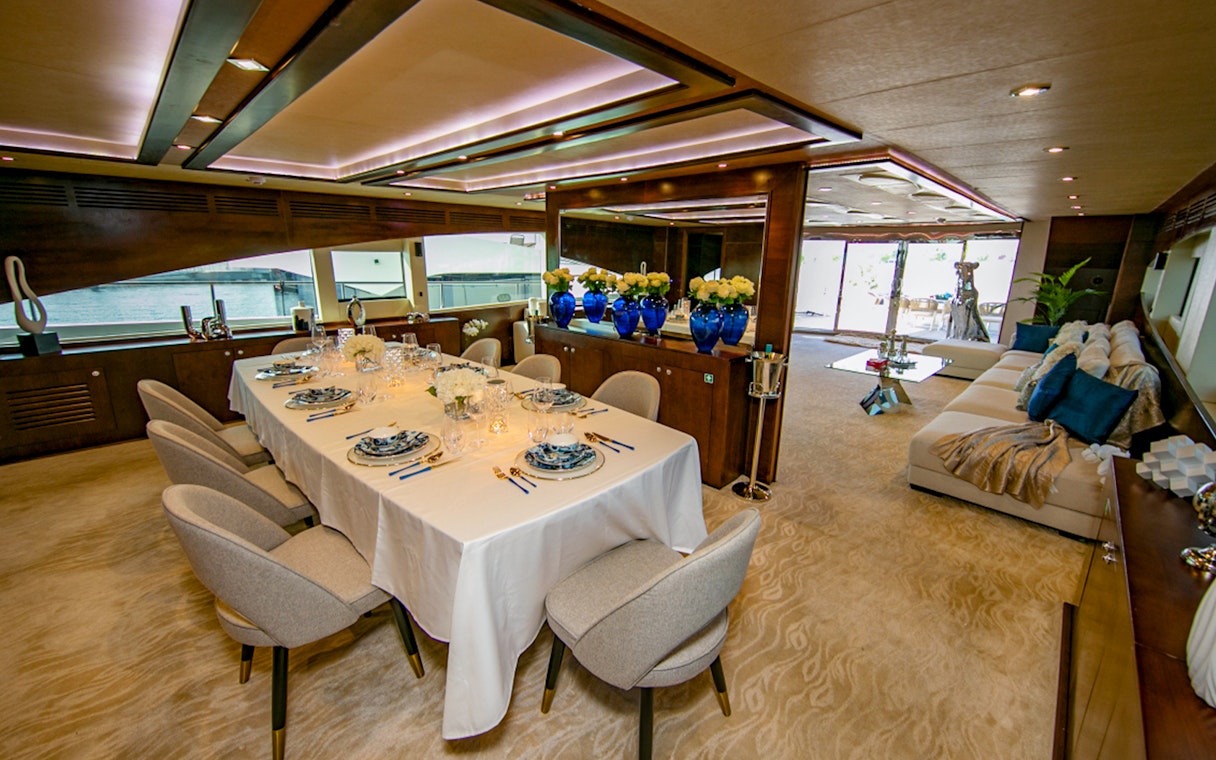 Superyacht TriDeck dining area with elegant table setting and ocean view.