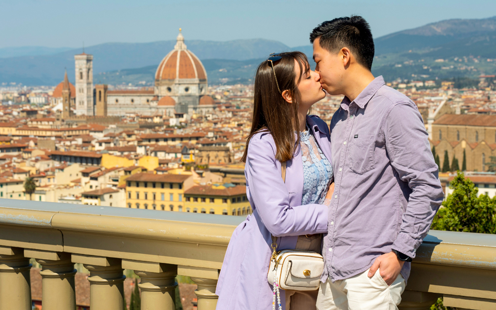 Couple kissing with Florence skyline and Duomo in the background.