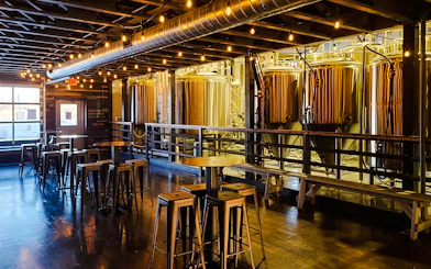 Fairbanks brewery interior with fermentation tanks and seating area on the Arctic Ale Trail tour.