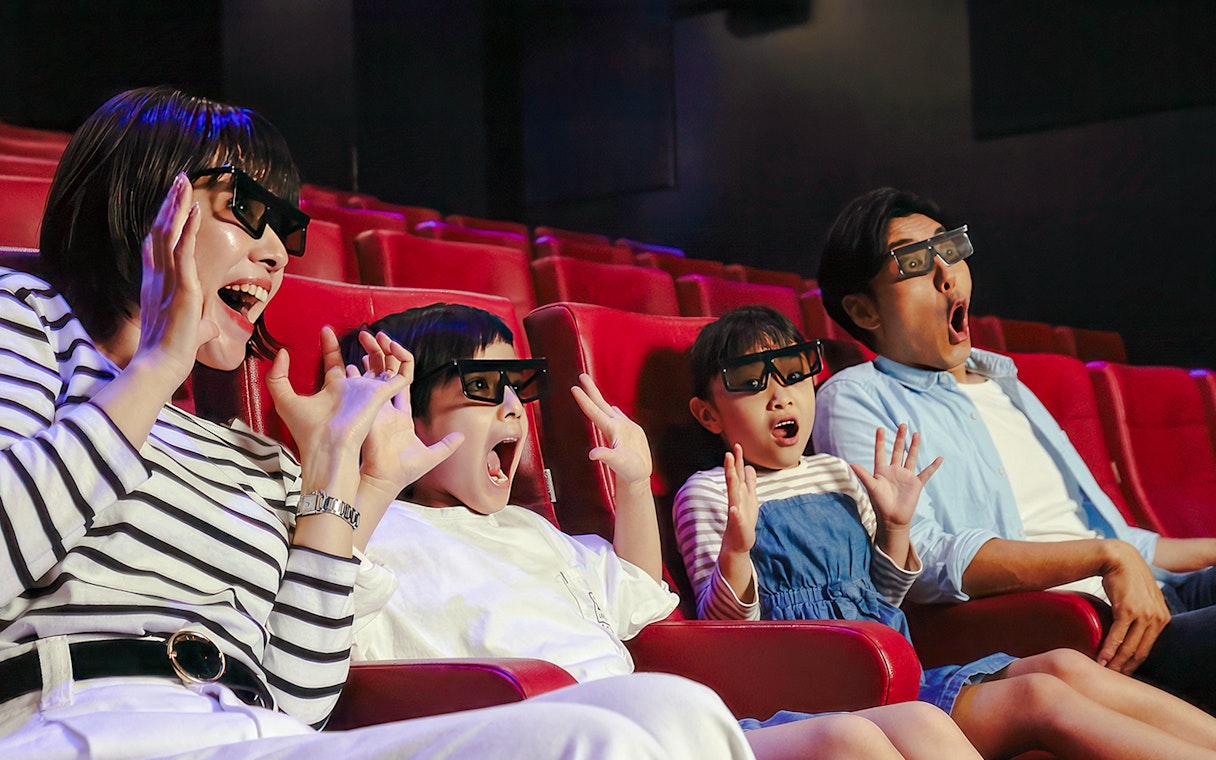Family enjoying 4D cinema experience at LEGOLAND Discovery Center Osaka.