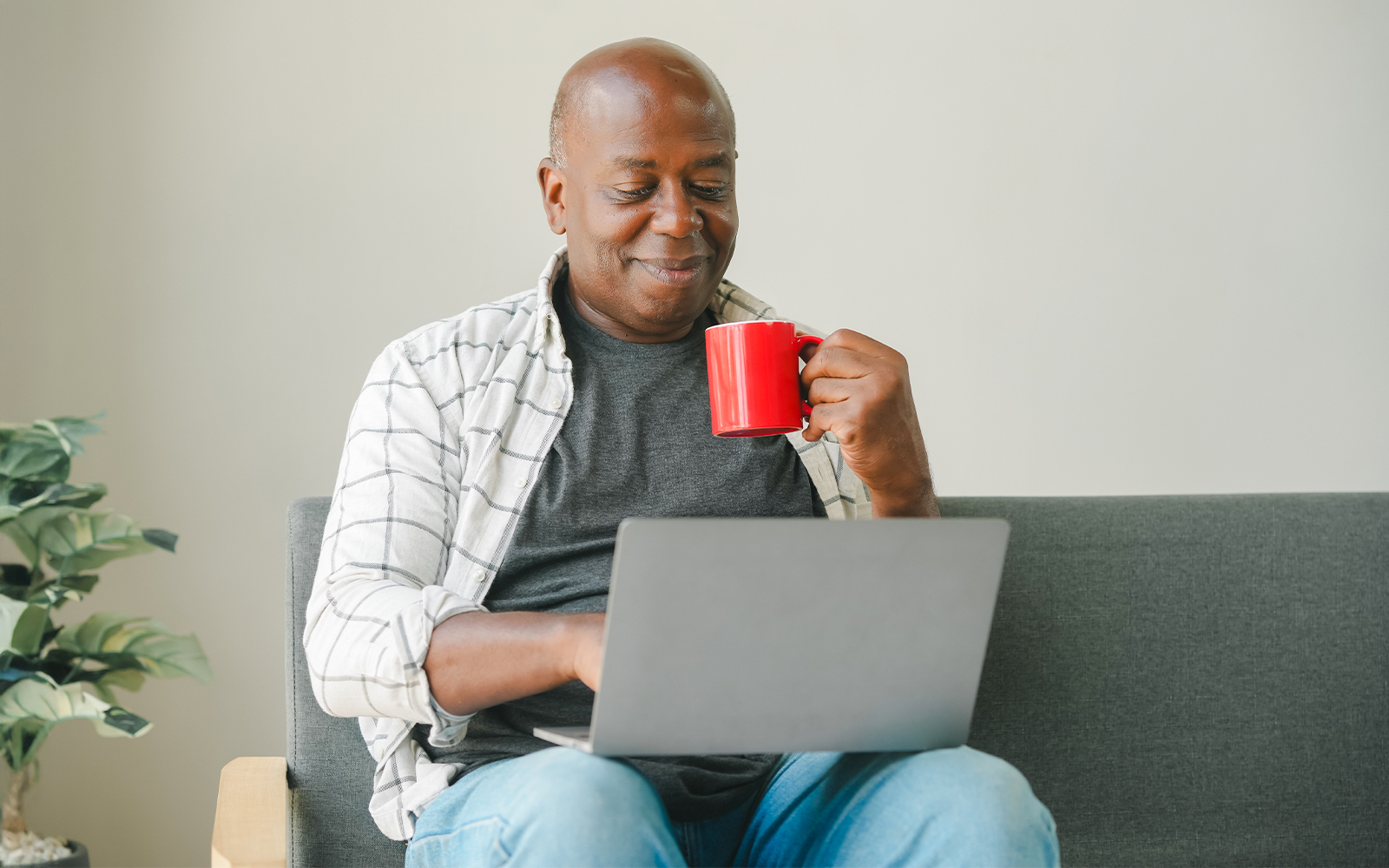 man on couch with laptop