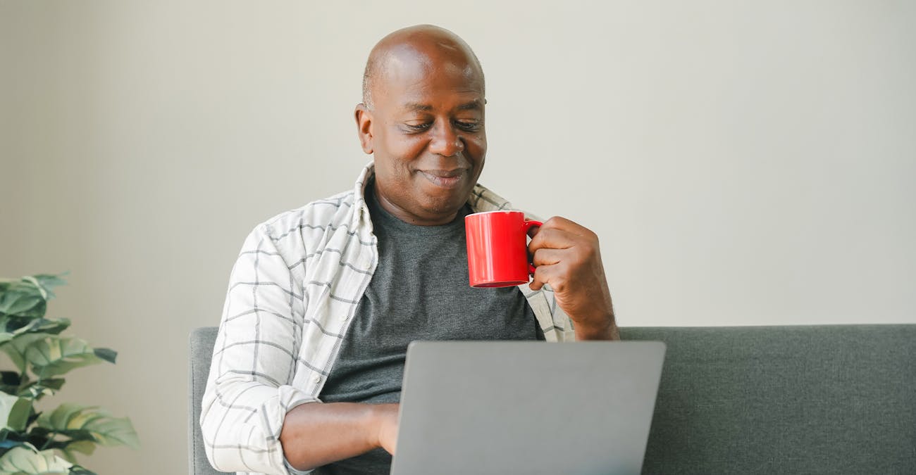 man on couch with laptop
