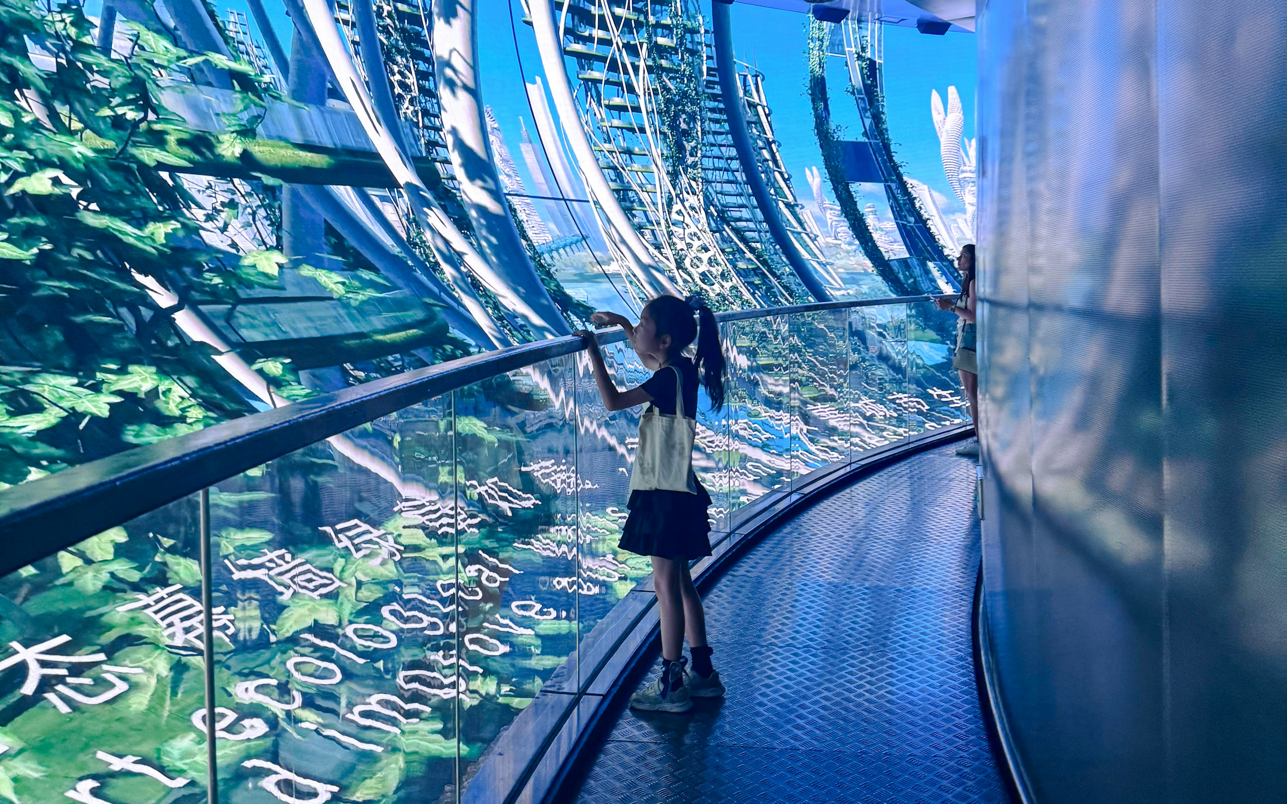 Girl observing digital display at 78m Multimedia Show Gallery, Oriental Pearl Tower, Shanghai.