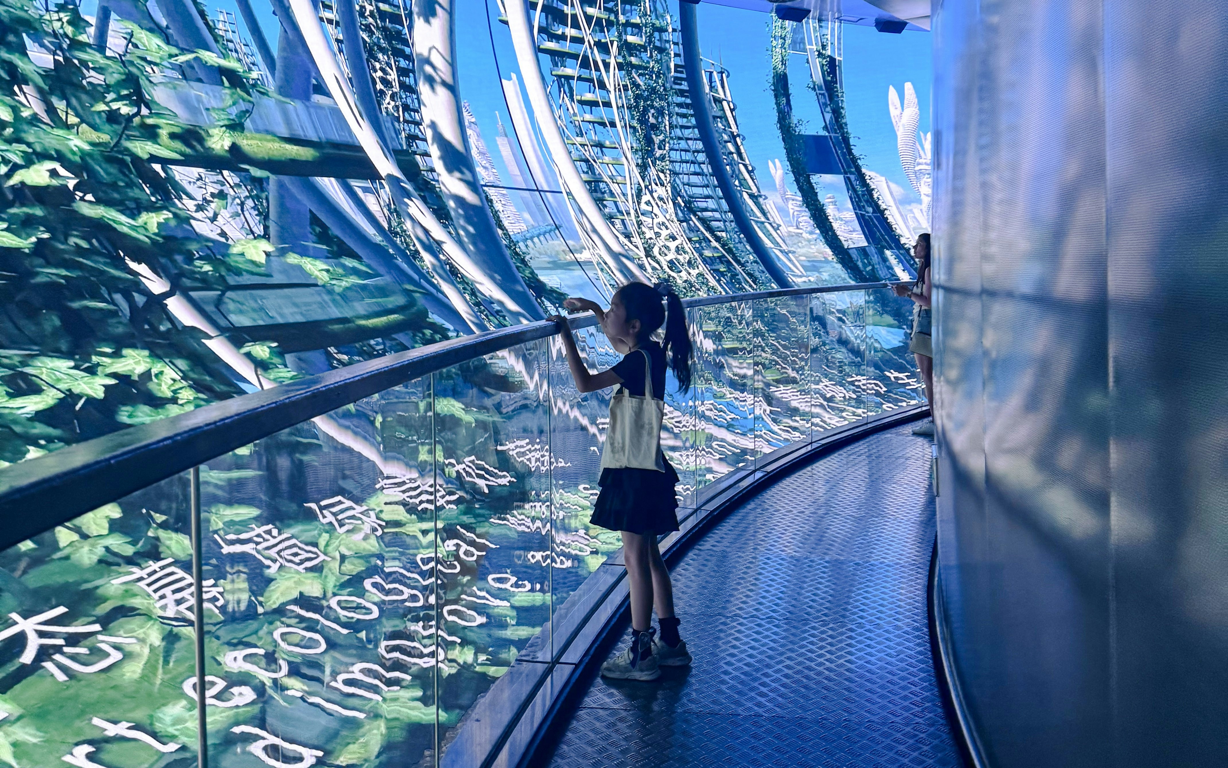 Girl observing digital display at 78m Multimedia Show Gallery, Oriental Pearl Tower, Shanghai.