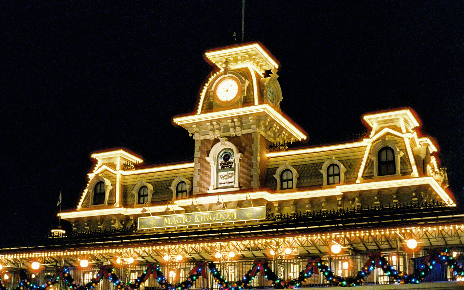 Magic Kingdom entrance illuminated at night, Walt Disney Resort, Orlando.