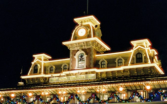 Magic Kingdom entrance illuminated at night, Walt Disney Resort, Orlando.