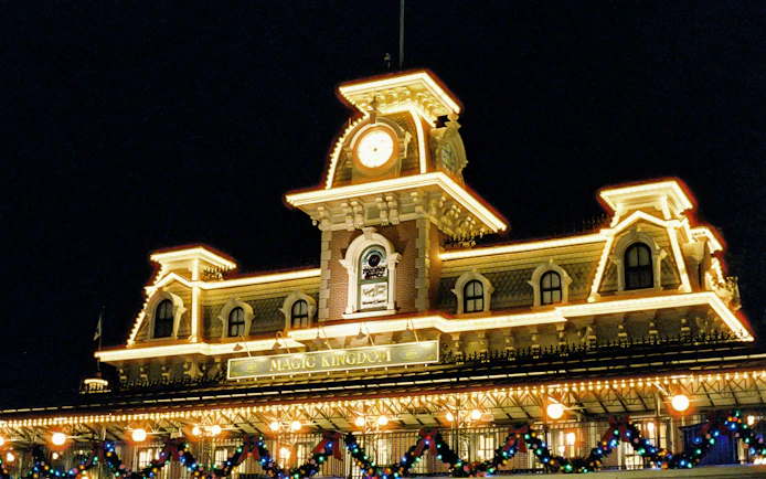 Magic Kingdom entrance illuminated at night, Walt Disney Resort, Orlando.