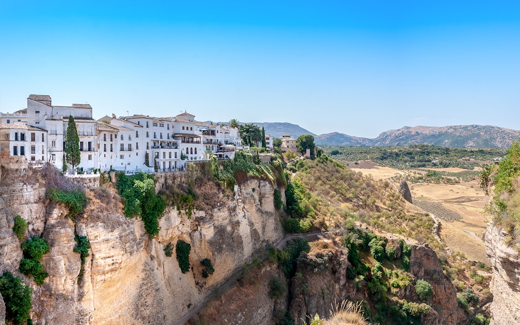 Setenil de las Bodegas cliffside houses with scenic valley view, Spain.