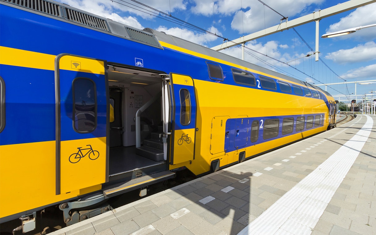 NS train at platform for transfer between Schiphol Airport and Amsterdam.