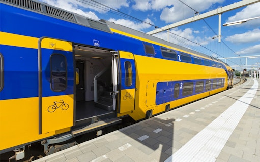 NS train at platform for transfer between Schiphol Airport and Amsterdam.