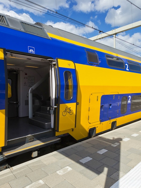 NS train at platform for transfer between Schiphol Airport and Amsterdam.