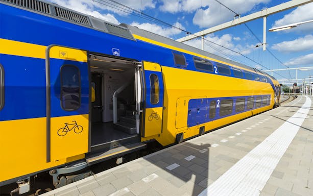 NS train at platform for transfer between Schiphol Airport and Amsterdam.