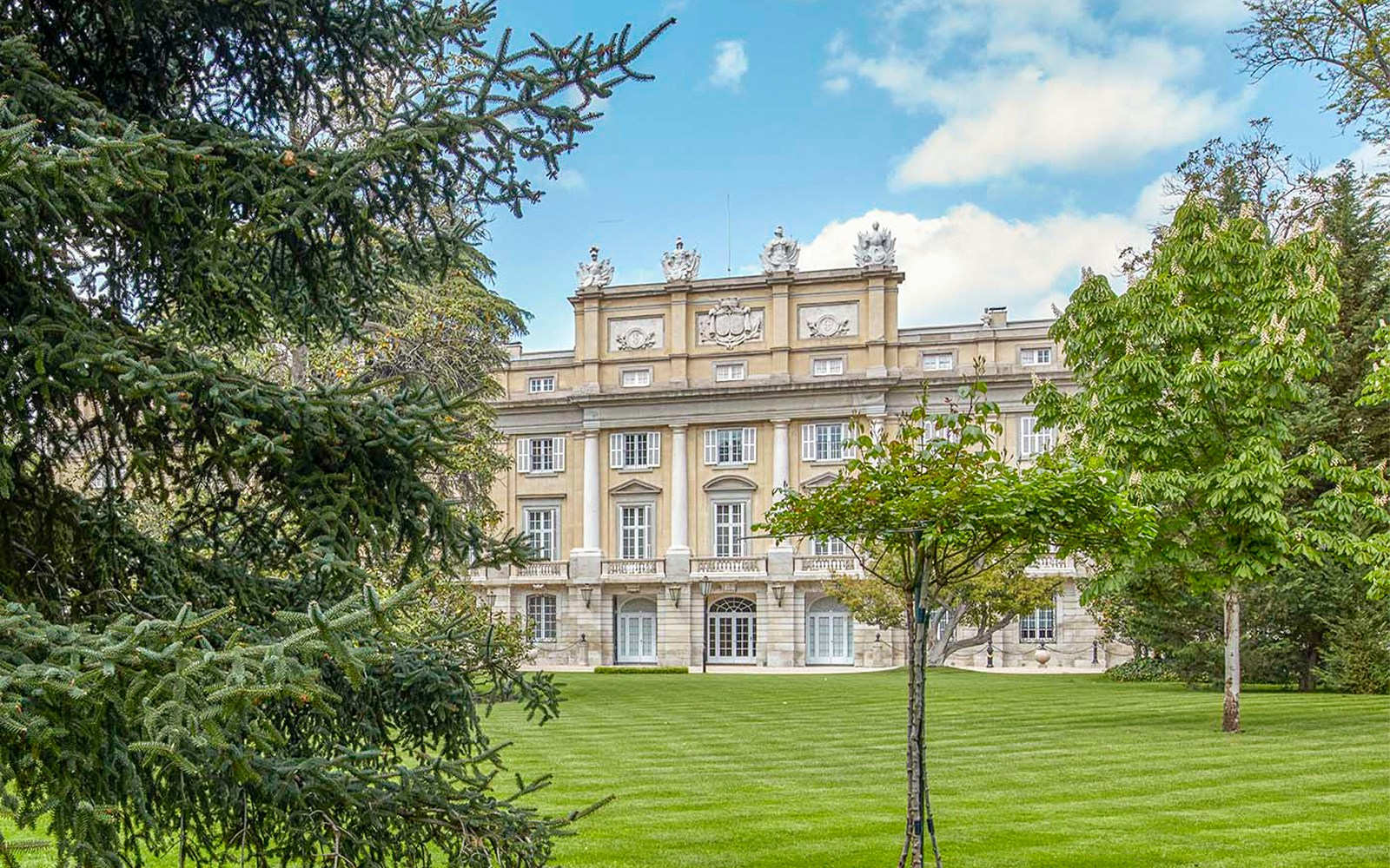 Gardens of Liria Palace with manicured hedges and historic architecture in Madrid, Spain.