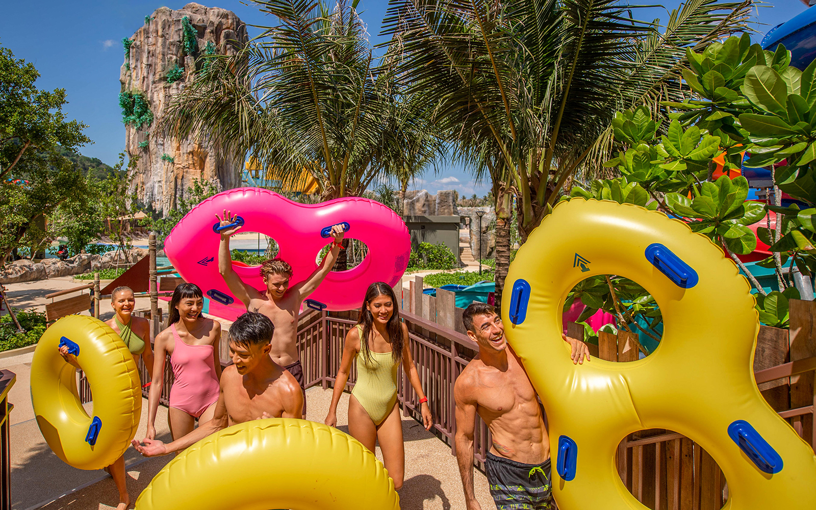 Group enjoying water park with inflatable tubes at Andamanda, Phuket.
